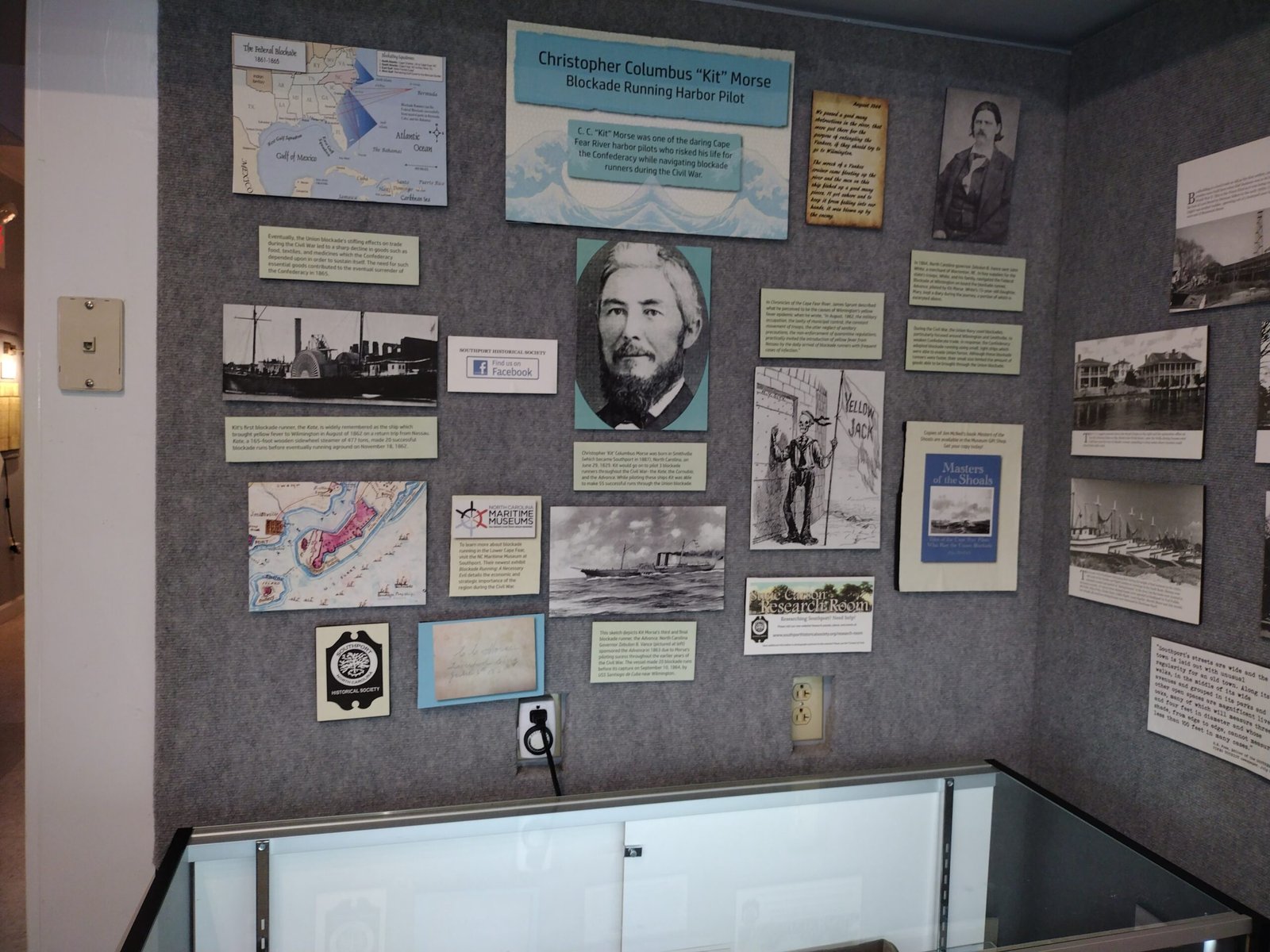 Wall of historic photographs and maps