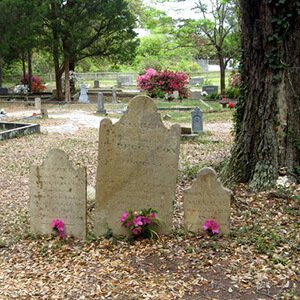 Weathered gravestones decorated with flowers